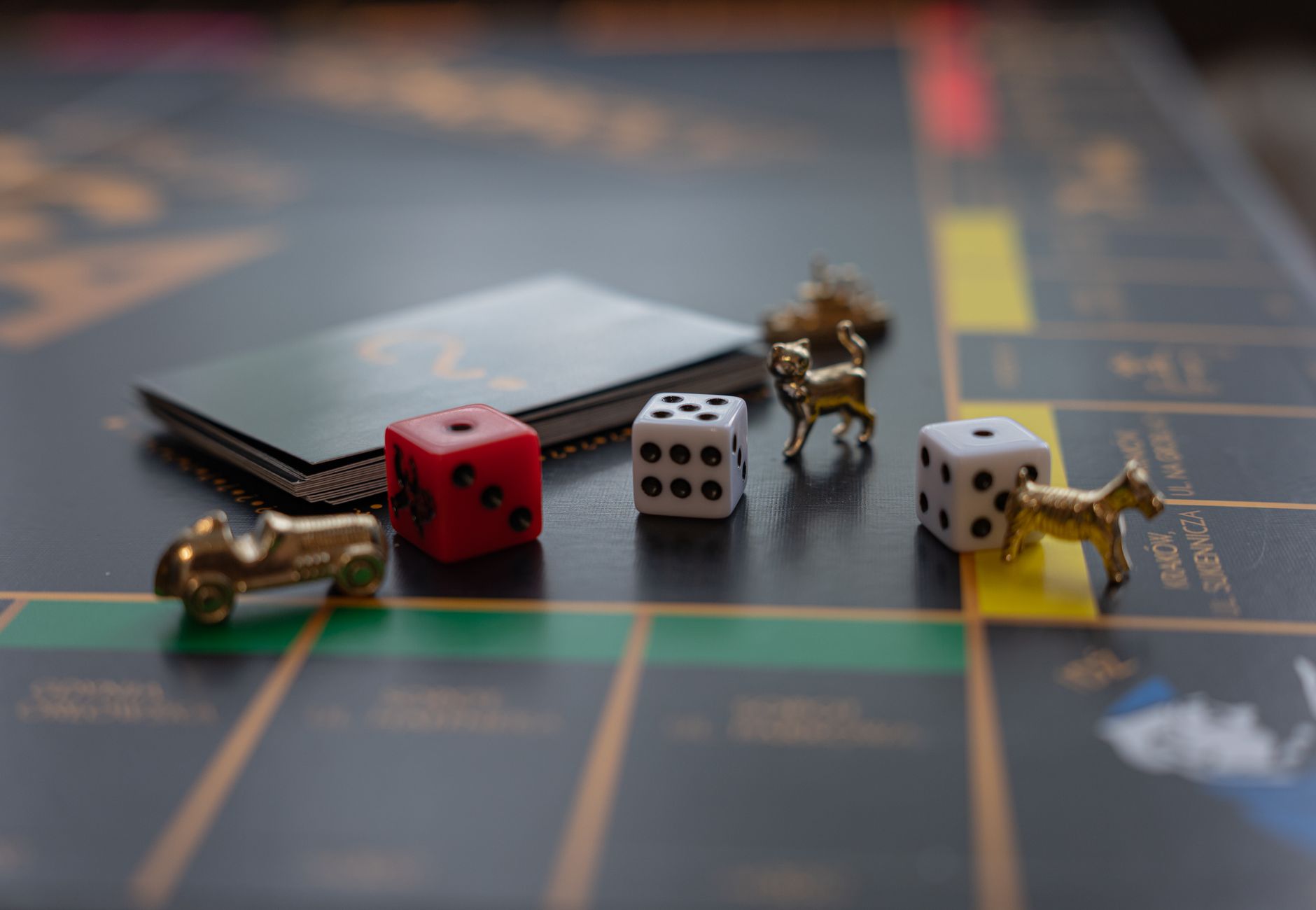 Close-up of Monopoly board game pieces including dice and tokens, perfect for family game night themes.