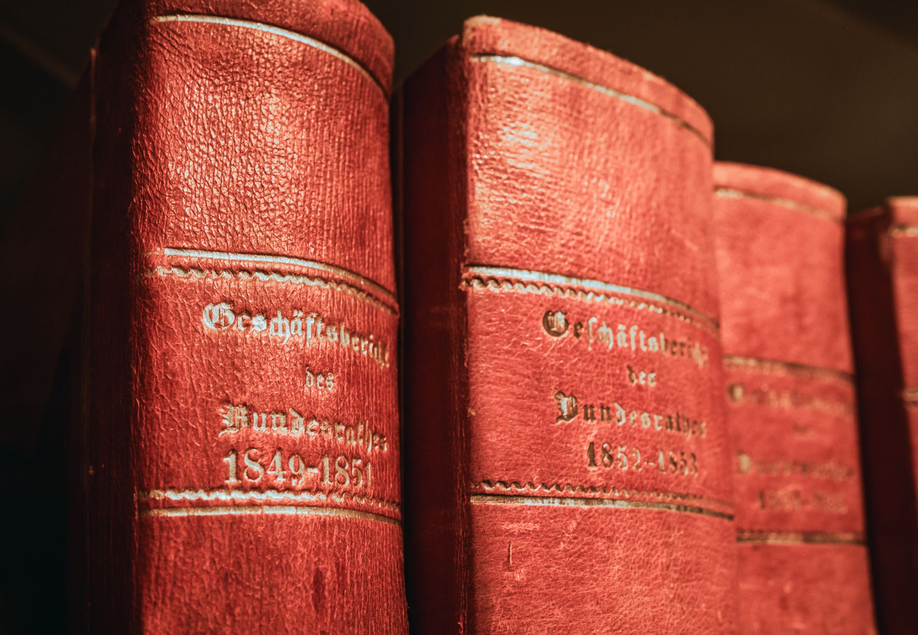 Red leather-bound parliamentary books from 19th century in Bern library, Switzerland.