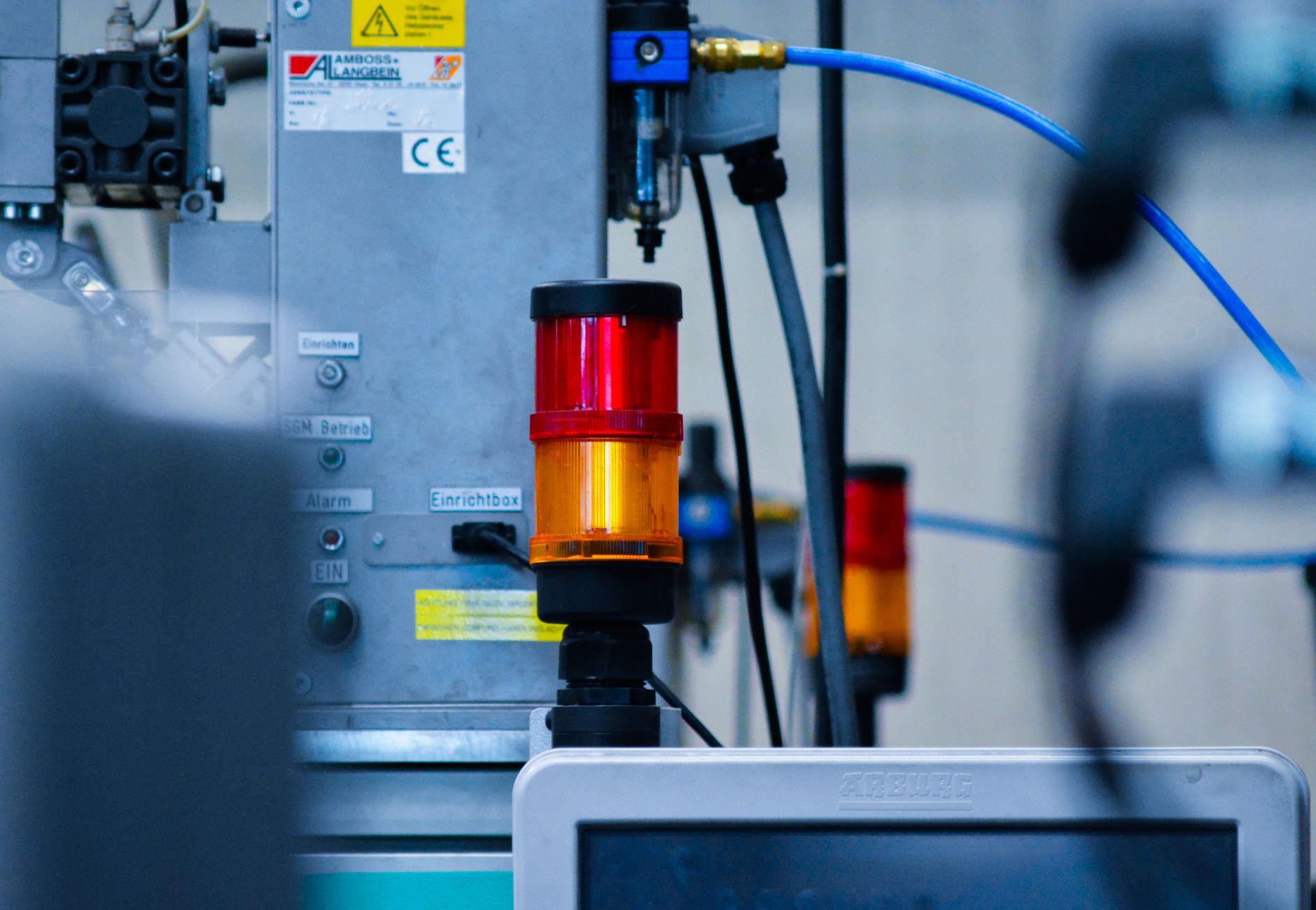 Detailed view of automated machinery with warning signals in an industrial setting.