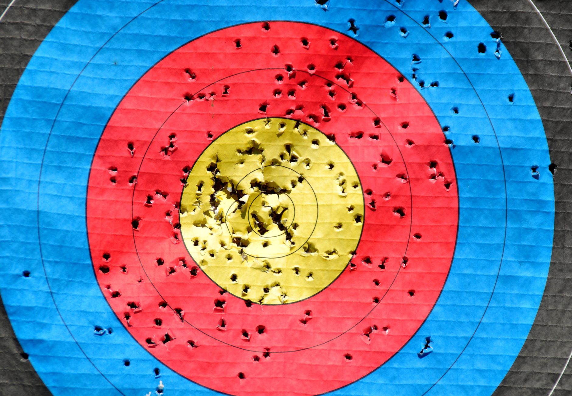 Vibrant archery target showcasing accuracy with multiple hits across colored rings.